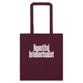 Burgundy cotton tote bag with Beautiful Intellectualist in soft cream condensed serif on the front